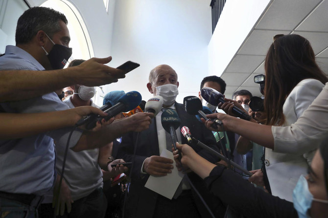 French Foreign Minister Jean-Yves Le Drian, wearing a mask to help prevent the spread of the coronavirus, speaks to journalists during his visit to the Carmel Saint Joseph school in Mechref district, south of the capital Beirut, Lebanon, Friday, July 24, 2020. (AP/Bilal Hussein)