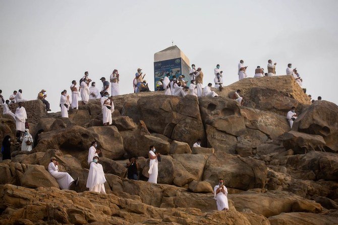 A handout picture provided by Saudi Ministry of Media on July 30, 2020 shows Muslim pilgrims praying on Mount Arafat, also known as Jabal al-Rahma (Mount of Mercy). (AFP)