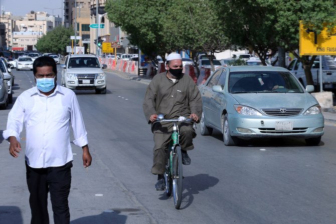 People wearing protective masks are seen in the street, after the government lifted coronavirus disease (COVID-19) lockdown restrictions, in Riyadh, Saudi Arabia July 5, 2020. (Reuters)