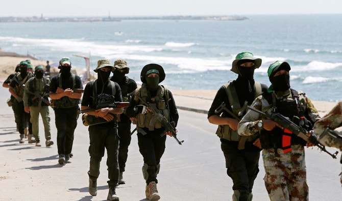 Palestinian Hamas militants march on a street at Beach refugee camp in Gaza City July 16, 2020. (REUTERS)