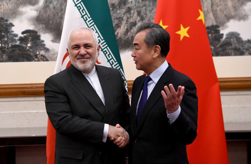 China’s FM Wang Yi and Iran’s FM Mohammad Javad Zarif at the Diaoyutai State Guesthouse, Beijing, Dec. 31, 2019. (Reuters)