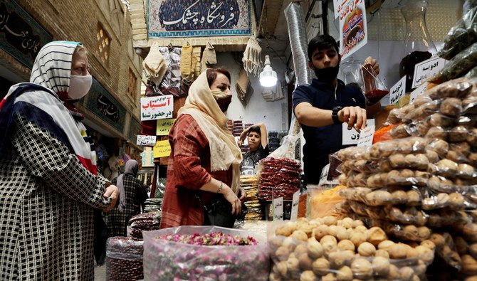 Women wearing face masks shop at a bazaar in Tehran. (Reuters)