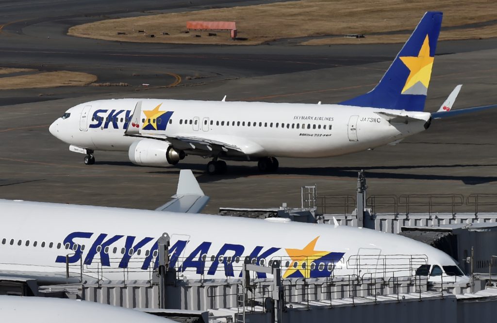 Passenger planes of Skymark Airlines park at Tokyo's Haneda airport on January 29, 2015. (AFP)