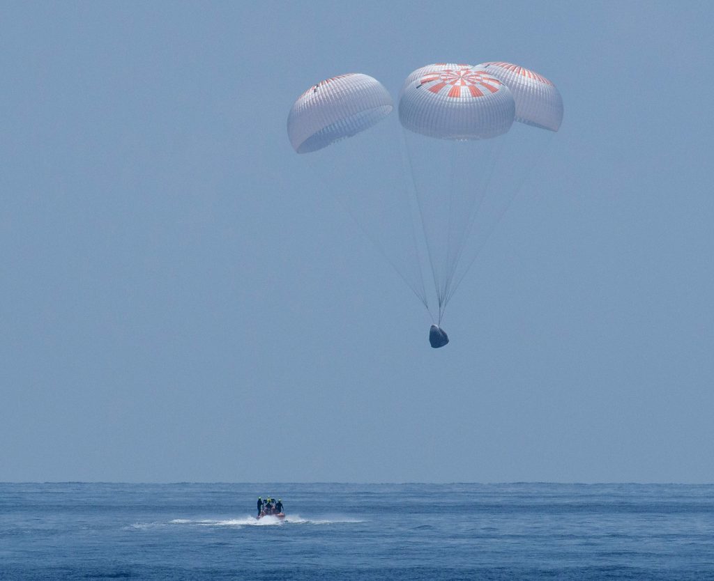 This NASA photo released August 2, 2020 shows the SpaceX Crew Dragon Endeavour spacecraft as it lands with NASA astronauts Robert Behnken and Douglas Hurley onboard in the Gulf of Mexico off the coast of Pensacola, Florida. The Demo-2 test flight for NASA's Commercial Crew Program is the first to deliver astronauts to the International Space Station and return them to Earth onboard a commercially built and operated spacecraft. (AFP PHOTO /NASA/BILL INGALLS)