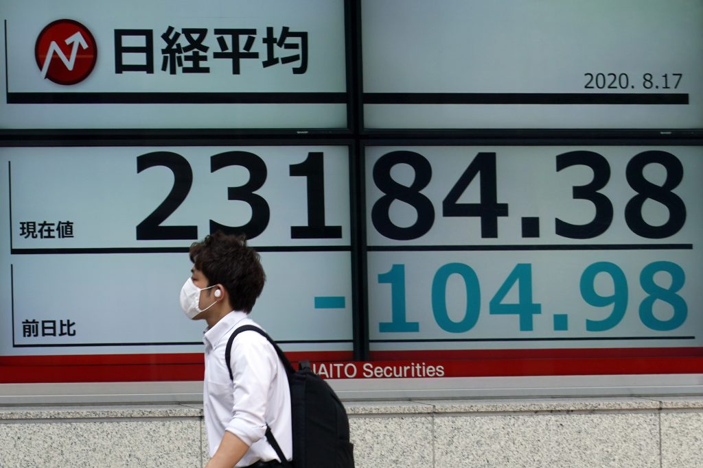 A man walks past an electronic stock board showing Japan's Nikkei 225 index at a securities firm in Tokyo Monday, Aug. 17, 2020. (File photo/AP)
