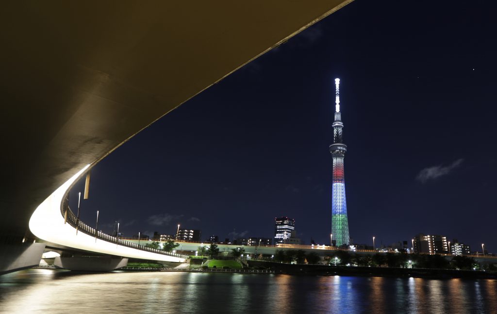 The Tokyo Skytree shows a special lighting in red, blue and green, the symbol colors of the Tokyo 2020 Paralympic Games, in Tokyo on Monday, Aug. 24, 2020. The lighting Monday marked one year to go before the planned opening of the Paralympics that was postponed this summer due to the coronavirus pandemic. (File photo/AP)