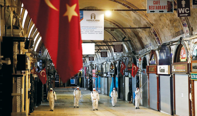 Workers in protective suits spray disinfectant at the Grand Bazaar, known as the Covered Bazaar, to prevent the spread of coronavirus in Istanbul. (Reuters/File)