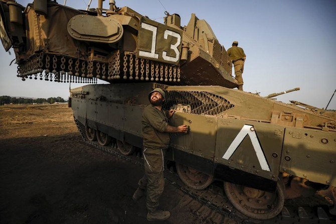 A soldier prepares a Merkava battle tank stationed in the Israeli-annexed Golan Heights on July 28, 2020, as the army reinforces and updates forces at its northern command. (AFP)