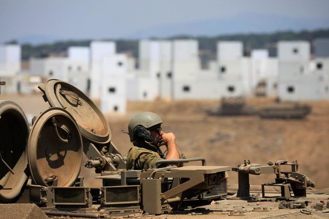 Above, an Israeli soldier aboard an armored personnel carrier as it maneuvers in the Israeli-controlled Golan Heights near the Israel-Syria frontier August 4, 2020. (Reuters)