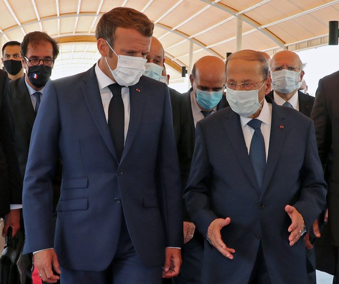 A handout picture shows Lebanon's President Michel Aoun (R) receiving French President Emmmanuel Macron at the airport near the capital Beirut, on August 6, 2020. (Dalati and Nohra photo)