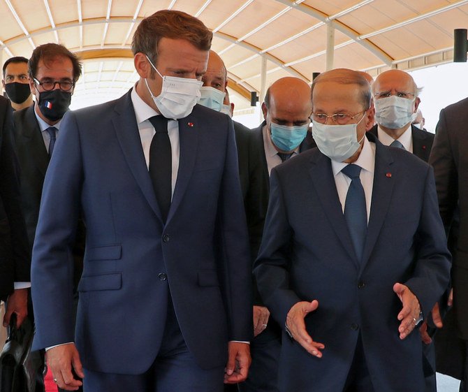 A handout picture shows Lebanon's President Michel Aoun (R) receiving French President Emmmanuel Macron at the airport near the capital Beirut, on August 6, 2020. (Dalati and Nohra photo)