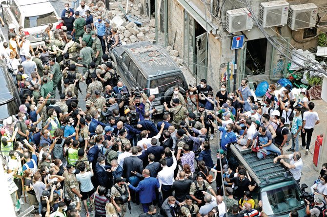 Crowds calling for political change surround the French leader during a visit to the Beirut port area. (AFP) 