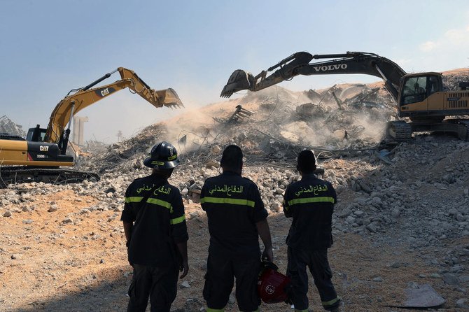 A rescue team watch diggers tackle the removal of debris from this week's massive explosion in the port of Beirut, Lebanon, Friday, Aug. 7, 2020. (AP)