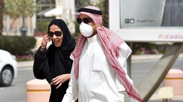 A Saudi man walks with his wife along Tahlia street in the center of the capital Riyadh. (File photo: AFP)