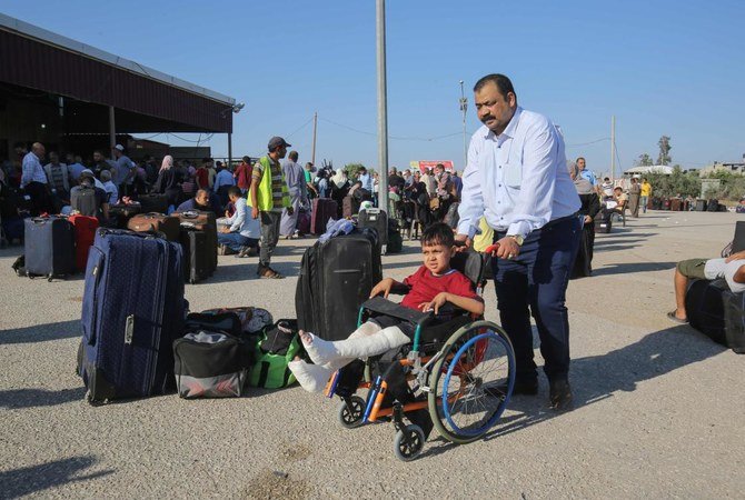 Palestinians wait to cross to the Egyptian side of Rafah border crossing after months of closure due to the coronavirus pandemic on August 11, 2020. (AFP)