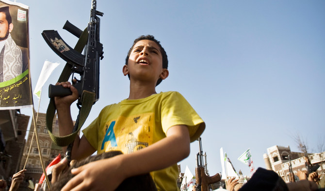 A boy holds a weapon while Shiite rebels known as Houthis protest against coalition airstrikes, during a rally in Sanaa, Yemen, Wednesday, April 1, 2015. (AP)