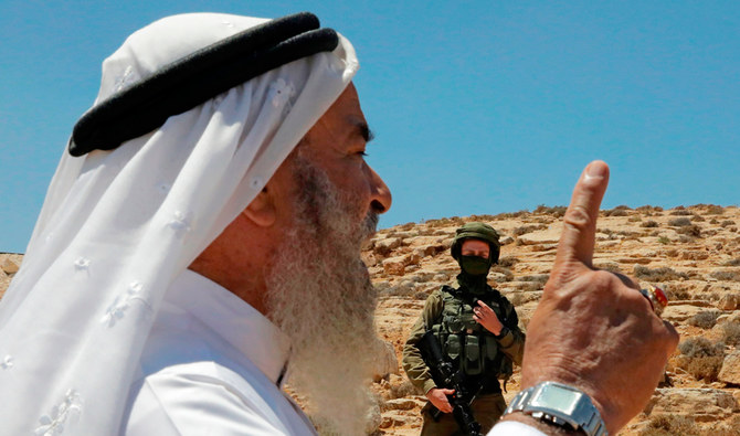 A man gestures during a protest by Palestinians including landowners denouncing Israeli settlement building activities on their land in Al-Thaalaba village, near Yatta in area (C), south of Hebron city in the occupied West Bank, on August 21, 2020. (AFP)