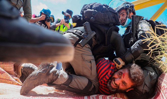 Members of the Israeli security forces arrest a Palestinian demonstrator during a rally to protest against Israel's plan to annex parts of the occupied West Bank, in the village of Haris, southwest of Nablus, on August 21, 2020. (AFP)