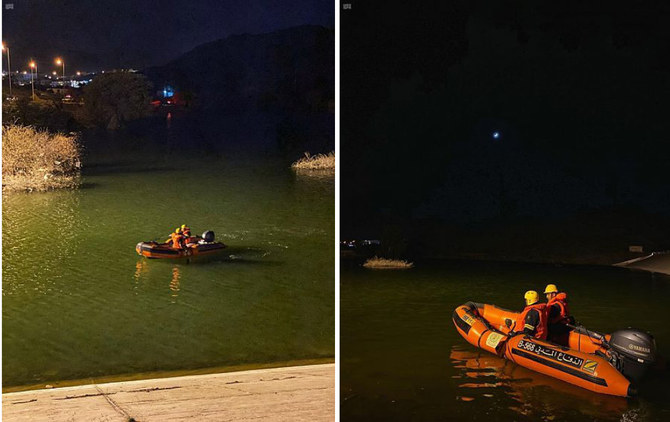 Rescuers from the Saudi Civil Defense Directorate are seen on an inflatable rubber boat in Taif's Wadi Saab dam on Saturday night. (SPA)