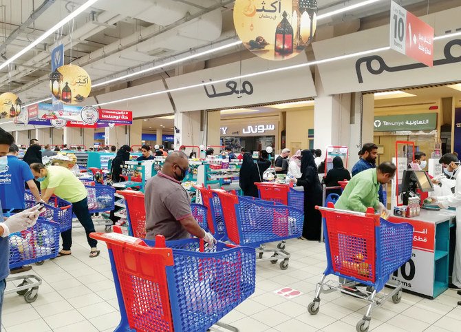 Customers queue to pay for groceries at a supermarket during the COVID-19 crisis. Some consumers say ‘the bad experience of the virus had made them aware of the importance of saving money.’ (AFP file photo)