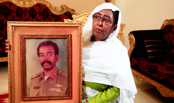Awatef Mirghani holds a portrait of Esmat Mirghani, a Sudanese officer who was executed in 1990, during an interveiw with AFP in her home in the capital Khartoum on July 27, 2020. (AFP)