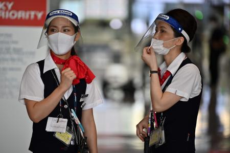 Airline employees wearing face shields work at the Narita International Airport in Narita, Chiba Prefecture on August 19, 2020. (AFP)