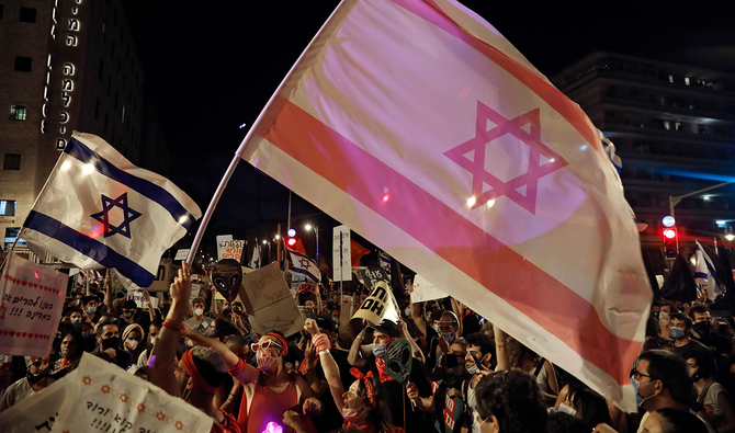 Protesters gather with Israeli flags during a demonstration against the Israeli government near the Prime Minister's residence in Jerusalem. (AFP)