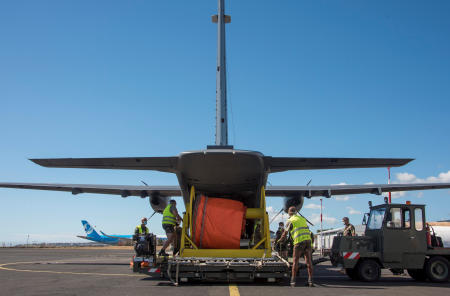 People prepare a plane carrying light equipment and pollution experts before it flies to Mauritius, following fuel spillage from the bulk carrier ship MV Wakashio, at Saint-Denis de la Reunion airport on the island of Reunion, France, in this handout image obtained by Reuters on August 11, 2020. (Reuters)