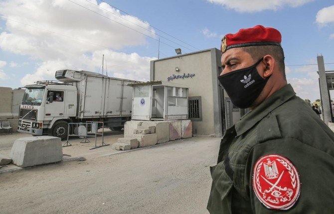 A member of Palestinian Hamas security forces stands outside the Kerem Shalom crossing in the southern Gaza Strip city of Rafah, on August 11, 2020. (AFP)