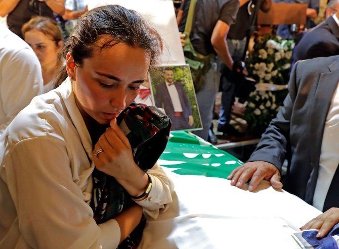 Karlen during the funeral of her husband Charbel Karam, brother Najib Hitti, and cousin Charbel Hitti in Qartaba, north of Beirut. The three firefighters were killed in the Aug. 4 explosion. (AFP)