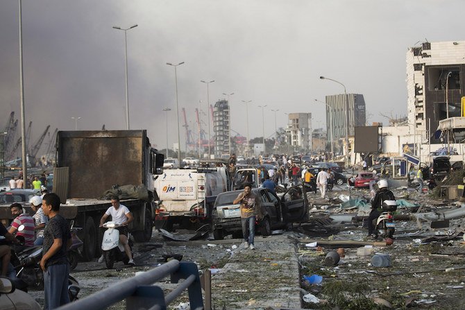 People evacuate wounded after of a massive explosion in Beirut, Lebanon, Tuesday, Aug. 4, 2020. (AP)