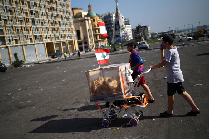 Two boys sell bread along a street following Tuesday's blast in Beirut's port area, Lebanon August 8, 2020. (Reuters)