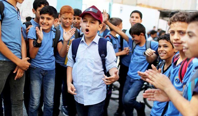 Abdel-Rahman Al-Shantti, an 11-year-old Gaza rapper, is surrounded by students as he performs in his school in Gaza City August 16, 2020. Picture taken August 16, 2020. (REUTERS)