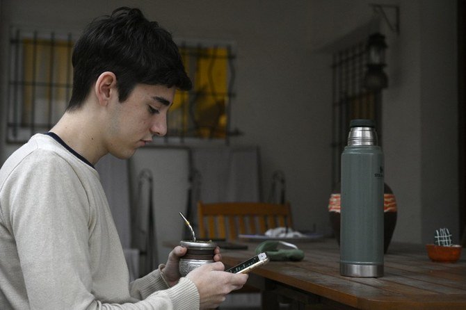 An Argentine youth uses his smart phone at his home in Bernal, Argentina amid the COVID-19 pandemic. (File/AFP)