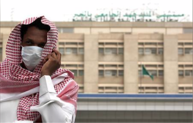 A man, wearing a surgical mask as a precautionary measure against the novel coronavirus, walks near a hospital in Khobar city in Dammam May 21, 2013. (Reuters)