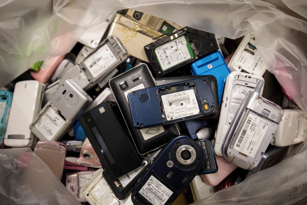 A pile of used mobile phones collected by the Tokyo Organising Committee of the Olympic and Paralympic Games is seen at the Tokyo Metropolitan Government building in Tokyo, as part of Tokyo 2020 Medal Project. (AFP)