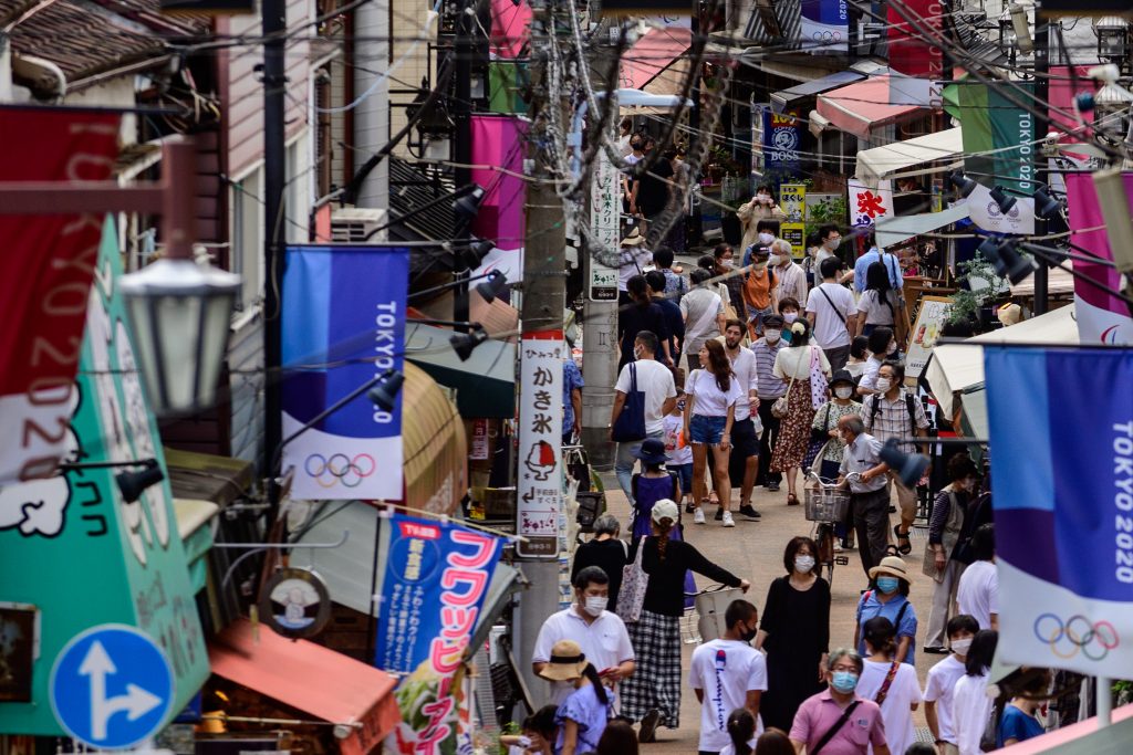 People wearing face masks as a preventive measure against the COVID-19 coronavirus visit Yanaka Ginza shopping street in Tokyo,  Aug. 1, 2020. (AFP)