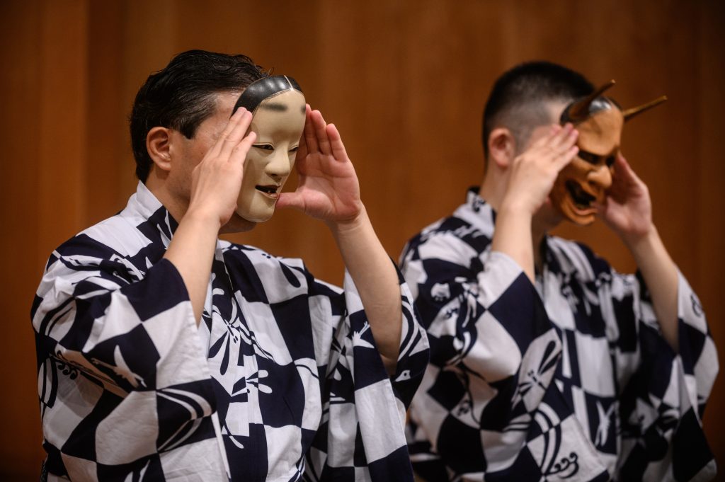This photo taken on July 29, 2020 shows performer Kanta Nakamori (L) and his son Kennosuke Nakamori putting on masks as they take part in a rehearsal at the Kamakura Noh Theatre in the town of Kamakura in Kanagawa Prefecture, about one hour southwest of Tokyo. (AFP)