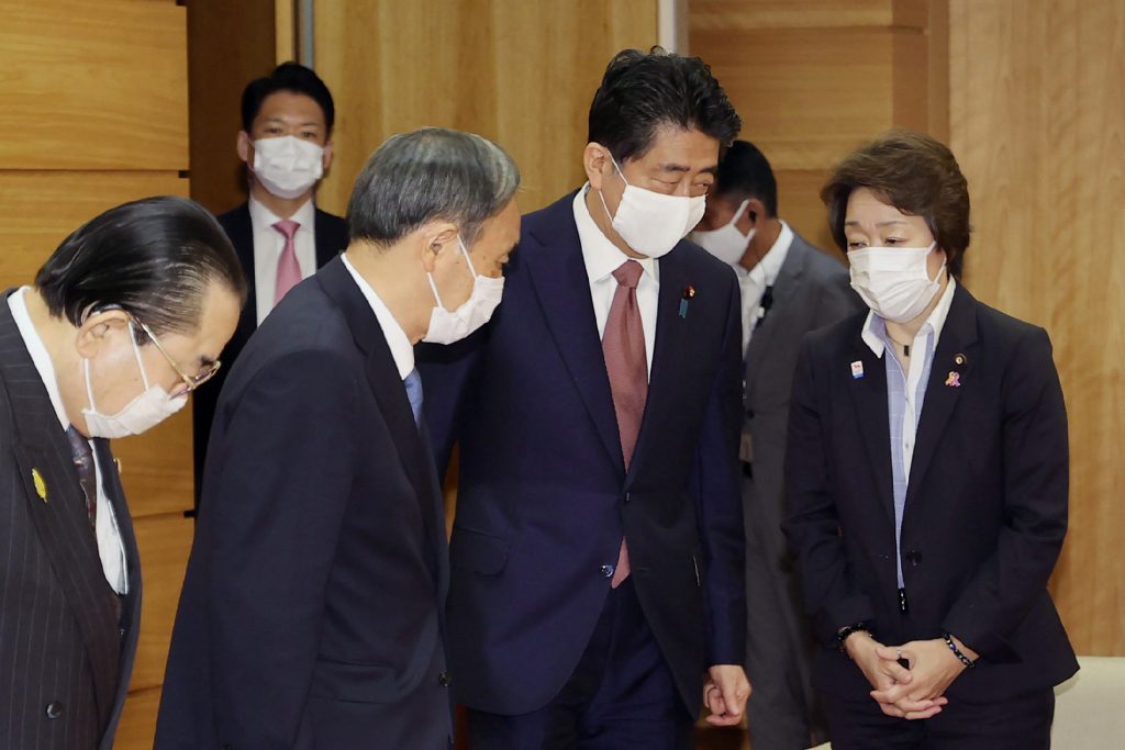 Japan’s outgoing Prime Minister Shinzo Abe (C-R) and Chief Cabinet Secretary Yoshihide Suga (C-L), the new leader of the Liberal Democratic Party attend their last cabinet meeting at prime minister's office in Tokyo on September 16, 2020. (AFP)