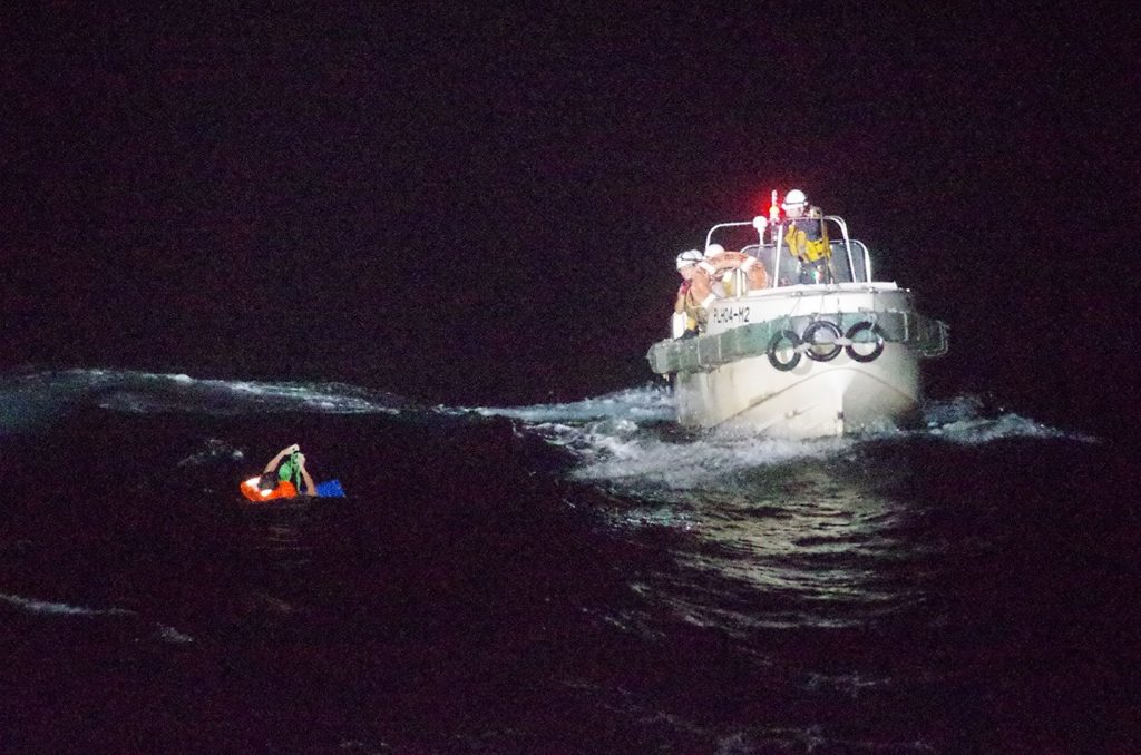 A Filipino crew member believed to be onboard Gulf Livestock 1, a cargo ship carrying livestock and dozens of crew members that went missing after issuing a distress signal due to Typhoon Maysak, is rescued by a Japan Coast Guard boat during their search and rescue operation at the East China Sea, to the west of Amami Oshima island in southwestern Japan, in this handout photo taken on September 2, 2020. (Reuters)