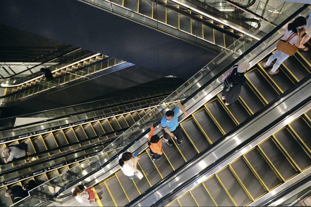 People take elevators at a shopping building in Tokyo on Aug. 24, 2020. Japan's economy shrank at a record, even worse rate in the April-June quarter than initially estimated. The Cabinet Office said Tuesday, Sept. 8, 2020, Japan's seasonally adjusted real gross domestic product contracted at an annualized rate of 28.1%, worse than the 27.8% figure given last month. (AP Photo)