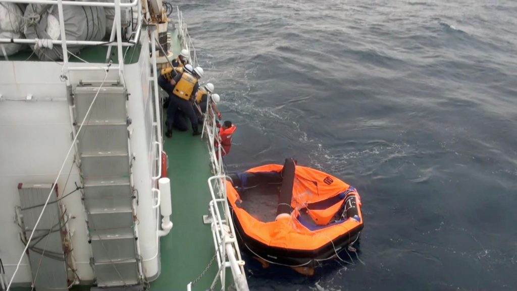 A Filipino crew member of Gulf Livestock 1, a cargo ship carrying livestock and dozens of crew that went missing after issuing a distress signal due to Typhoon Maysak, is rescued by Japan Coast Guard crew onboard the vessel Kaimon at the East China Sea, to the west of Amami Oshima island in southwestern Japan, in this still image taken from video September 4, 2020. (Courtesy 10th Regional Coast Guard Headquarters - Japan Coast Guard/Handout via Reuters)