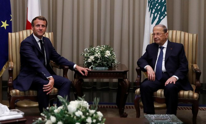 Lebanese President Michel Aoun welcomes French President Emmanuel Macron at Beirut International airport. (Reuters)