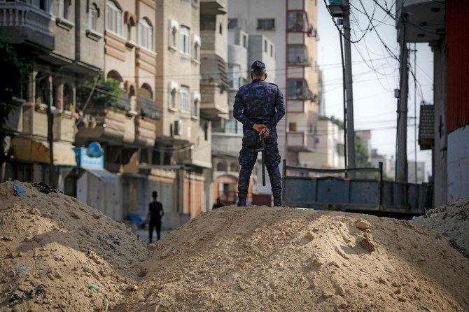 A Palestinian policemen stands at a road block preventing people to move from the northern to the southern Gaza Strip, on September 3, 2020 during a lockdown amid an outbreak of the Covid-19 disease. (AFP)