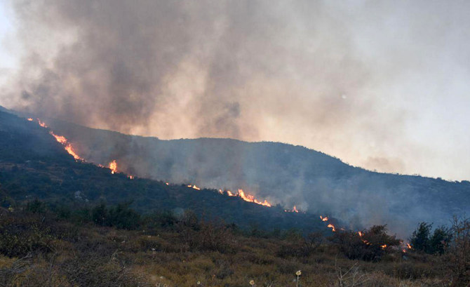 A handout picture released by the official Syrian Arab News Agency (SANA) on September 8, 2020 shows fires on a hill in Hazzur, in the western countryside of Hama Governorate. (AFP)