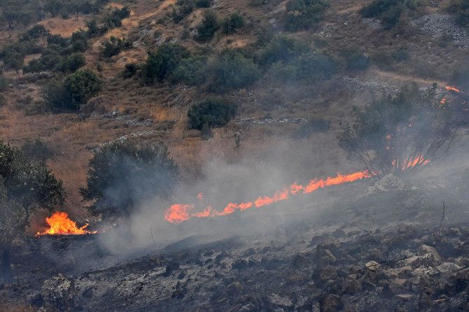 A handout picture released by the official Syrian Arab News Agency (SANA) on September 8, 2020 shows fires on a hill in Ain Halaqim, in the western countryside of Syria's Hama governorate. (AFP)