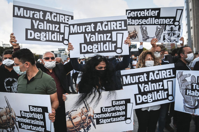 Demonstrators hold banners in support of jailed journalists on trial facing charges of revealing national security secrets, in front of a courthouse in Istanbul on Wednesday. (AFP)