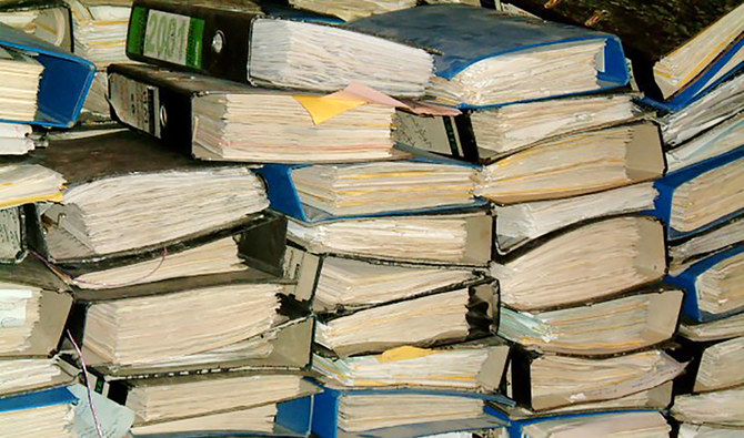 This handout picture provided by the Iraq Memory Foundation on September 10, 2020, shows documents that were found in one of the Baath Party’s headquarters in the Iraqi capital Baghdad at an unknown date, piled up after being collected by the foundation. (AFP)