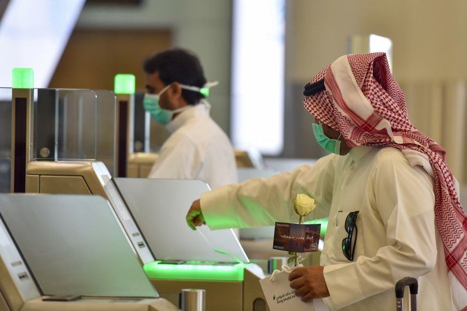 A Saudi passenger at terminal 5 in the King Fahad International Airport earlier this year. Saudis will be able to travel in and out of the country from Jan. 1. (AFP/File)