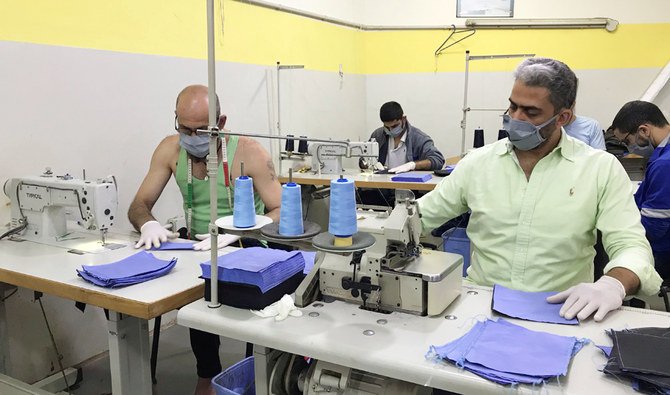 Inmates produce protective face masks, to be used by security members and inmates themselves as part of the preventive measures against the spread of the coronavirus disease (COVID-19), inside Roumieh prison, Lebanon, in this handout picture received by Reuters on April 6, 2020. (REUTERS)